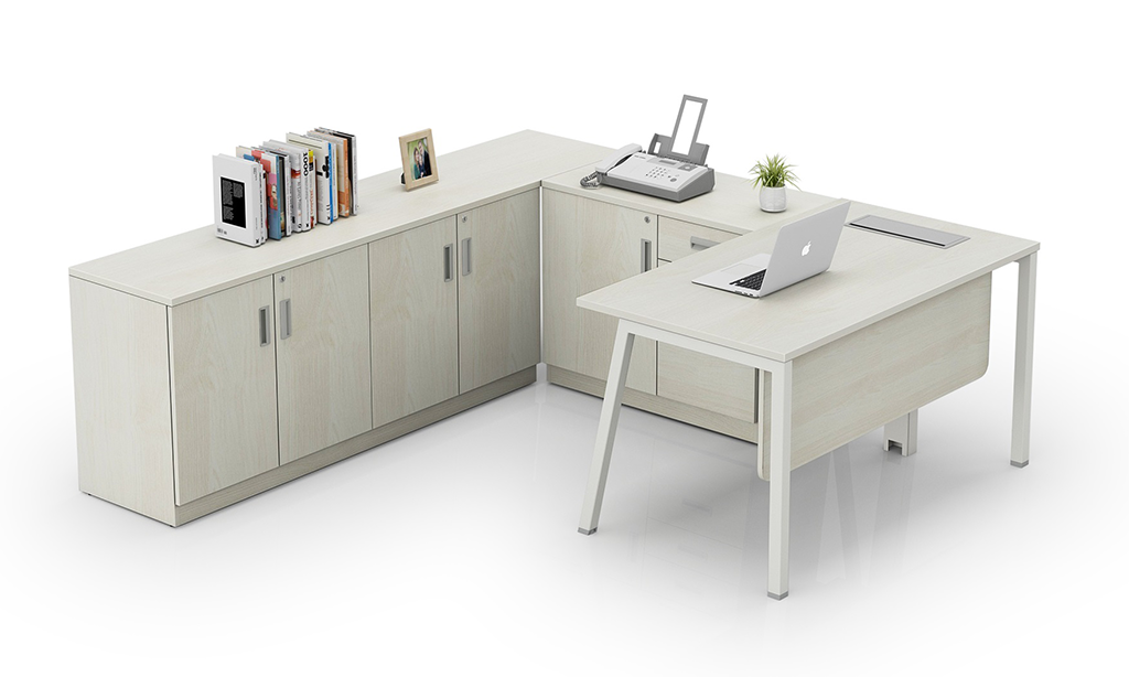 Executive office cabin table with a light wood finish, featuring a laptop, books, a printer, and a small plant.
